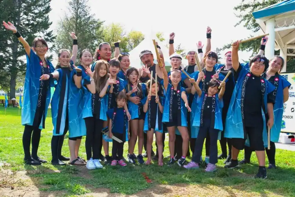 Smiling group of children and adults in traditional Japanese festival attire celebrating at KJCA Kamloops Japanese Canadian Cultural Centre.