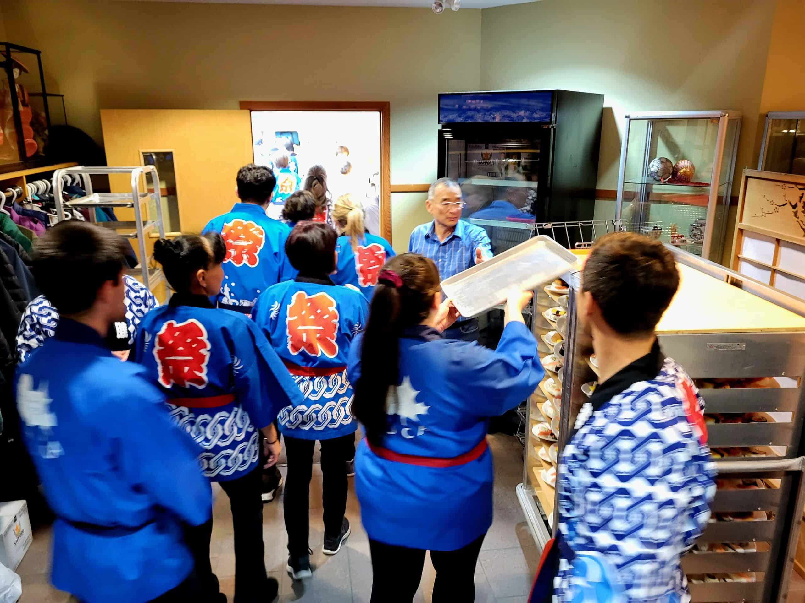 Traditional Japanese festival group wearing blue happi coats at Kamloops Japanese Canadian Cultural Centre.