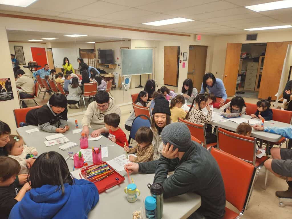 Colorful children and adults participating in a cultural activity at Kamloops Japanese Canadian Cultural Centre.