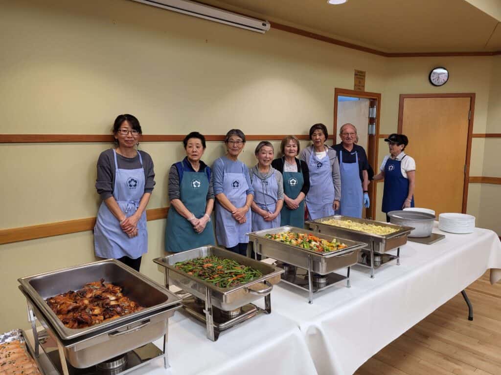 Volunteers at KJCA – Kamloops Japanese Canadian Cultural Centre preparing and serving traditional Japanese dishes for the community.